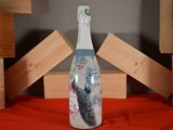 a bottle that has a picture of a peacock on it