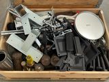 a wooden box filled with assorted metal items