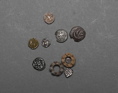 several different types of metal buttons on a gray surface