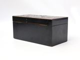an old black box with a marble top on a white background