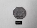 a small coin with a black and white label on it