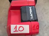 a close up of a red and black cordless driller
