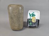 a vase and a plate sitting next to each other on a table