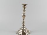 an antique silver plated candle holder on a white background