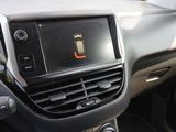 the dashboard of a car with a cell phone in the center of it