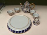 a picture of a tea set with a plate and cups