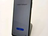 a close up of a cell phone sitting on top of a table