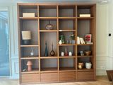 a wooden bookcase with many different items on it