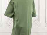 the back of a green t - shirt on a mannequin mannequin