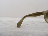 a pair of sunglasses on a bed with a white background