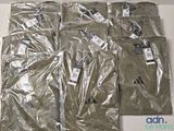 six bags of clothing sitting on a white table