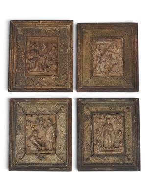 four pieces of wood with carvings of people and animals on them
