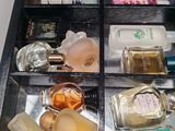 many different perfumes in a glass case on a table