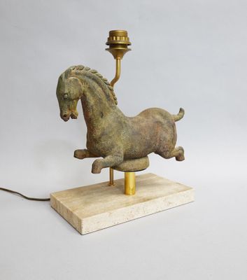 an image of a statue of a horse on a wooden base