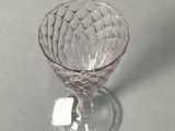 a small glass cup that is sitting on a table