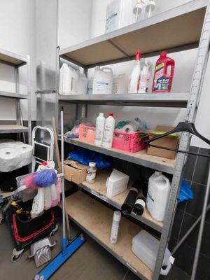 many shelves with cleaning supplies on them in a room