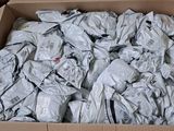 a cardboard box filled with a lot of crumpled clothes