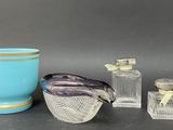 three glass vases and a blue vase on a table