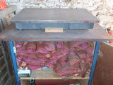 a metal shelf with a bunch of pink shoes on it