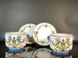 three cups and saucers sitting on a table