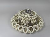 a picture of a white and black broochle with a skull on it