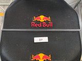 a pair of red bull seat covers on a toilet