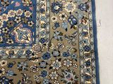 an oriental rug with a blue border and floral design on it