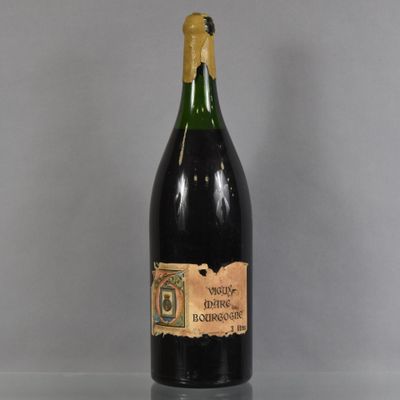 an old bottle of wine sitting on top of a table