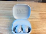 a pair of ear buds in a case on a table