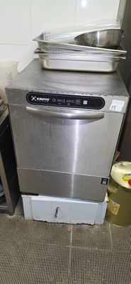 a silver dishwasher sitting next to a stove in a kitchen