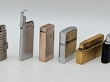 several lighters are lined up in a row on a white surface
