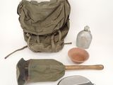a bag, a bottle, a spoon, and other items on a white surface