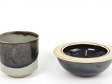 two bowls that are sitting side by side on a white surface