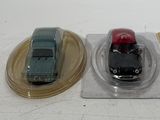 three toy cars sitting on top of each other on a table