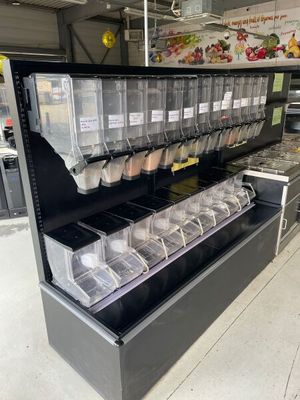 a display case with many containers of food inside of it