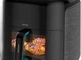 un gros plan sur une friteuse à air chaud contenant des pizzas