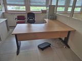 a desk with a chair and a foot stool in an office