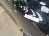 a black car with a sticker on the side of it
