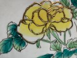 a yellow rose on a white plate with green leaves