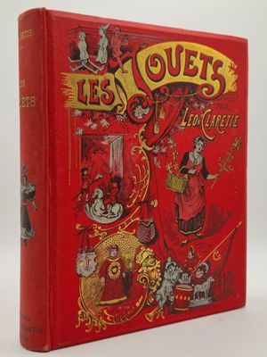 un livre rouge sur lequel figurent un clown et d'autres personnages