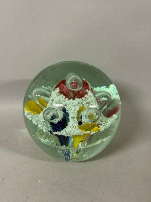 a glass object with a bunch of different colored objects inside of it