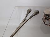 two spoons and a spoon rest on a glass table