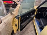 a car that has a door open and a seat in it