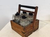 une caisse en bois contenant six bouteilles, posée sur une table