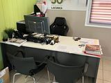 a desk with two chairs and a computer on it