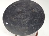 a black table with a black top on a wooden stand