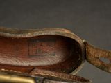 an image of a close up of a leather shoe with a metal buckle