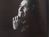 an old black and white photo of a man with his hand on his chin