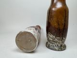two vases sitting next to each other on a table