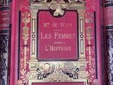 a red book on a shelf with a gold frame on it